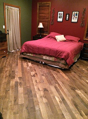 Organic Masala solid hardwood flooring installed a bedroom.
