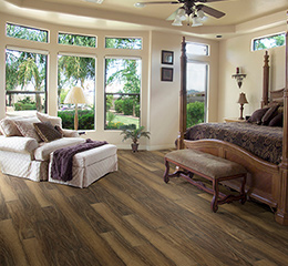 Product Argo Walnut, Polaris Waterproof flooring in a bedroom by Hallmark Floors